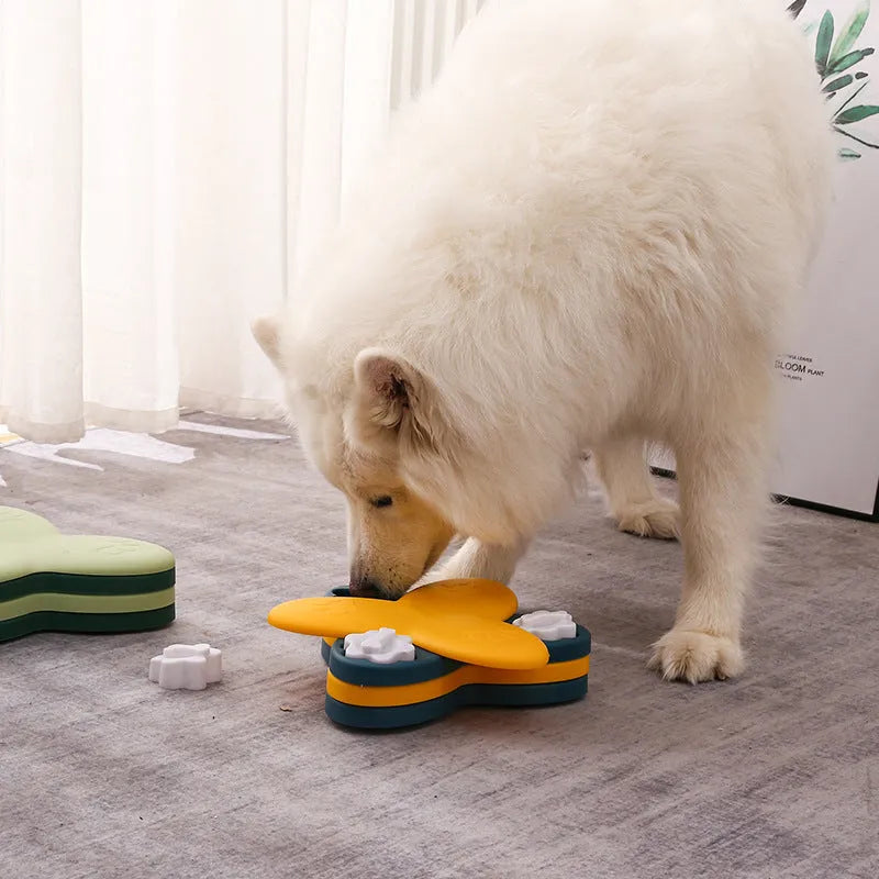 Yellow spinning dog slow food toy carousel on a light background, 24.5cm plastic interactive feeder