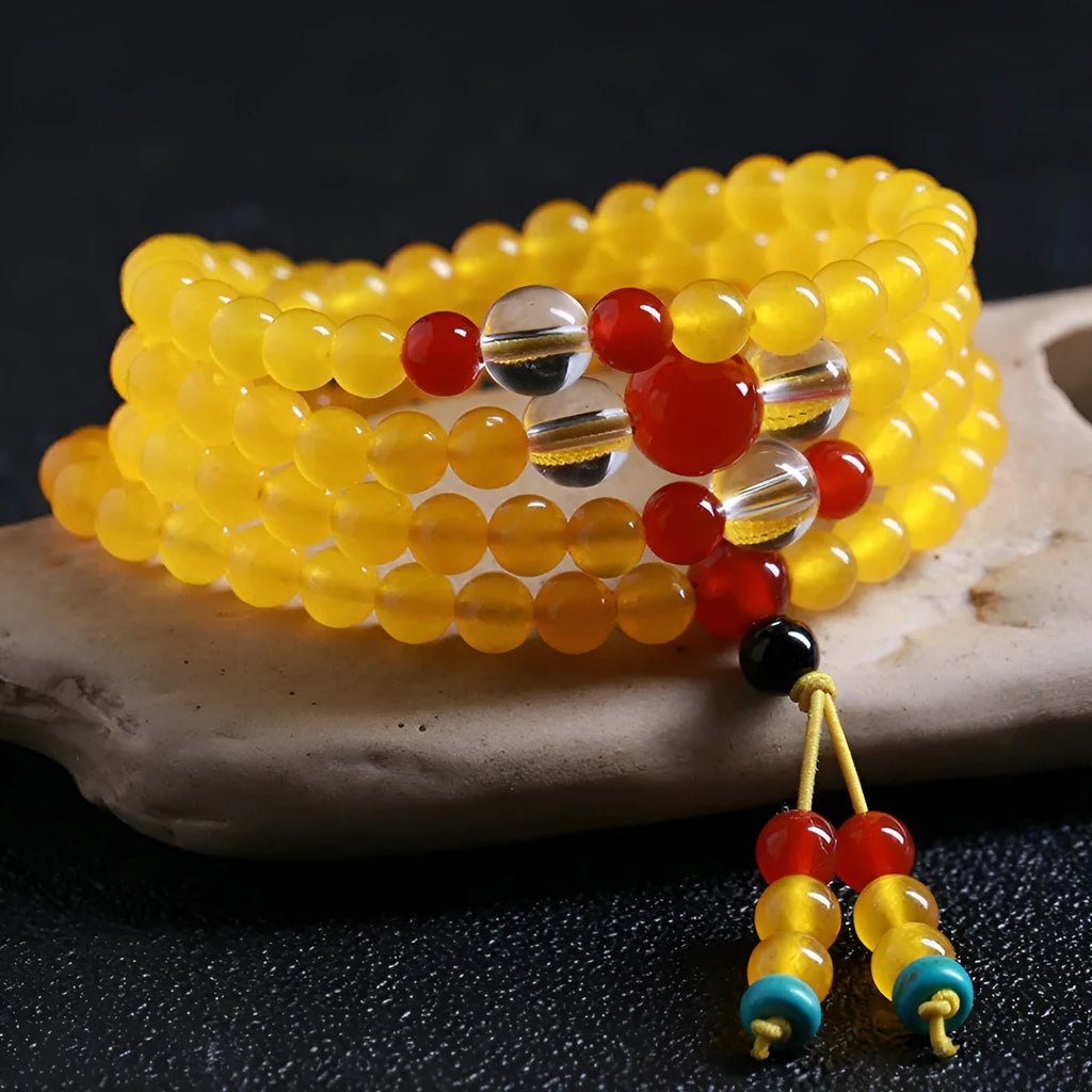 108-bead polished agate and crystal necklace with geometric beads and matching canary stone bracelet on display