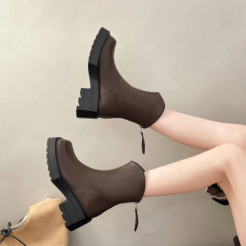 Black women's platform ankle boots with square toe, chunky sole, and rear zip fastening.
