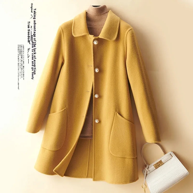 Women's wool double-faced mid-length coat with pearl buckle, doll collar, and front pockets in solid colour