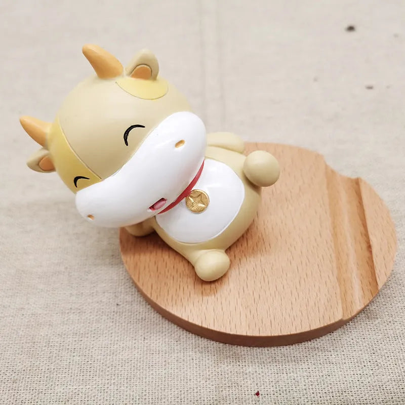 Beech wood mobile phone holder with resin animal design and coin slot