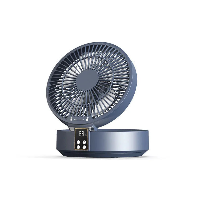 White portable folding fan with night light on a table, remote control beside it, showing its compact size.