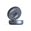 White portable folding fan with night light on a table, remote control beside it, showing its compact size.