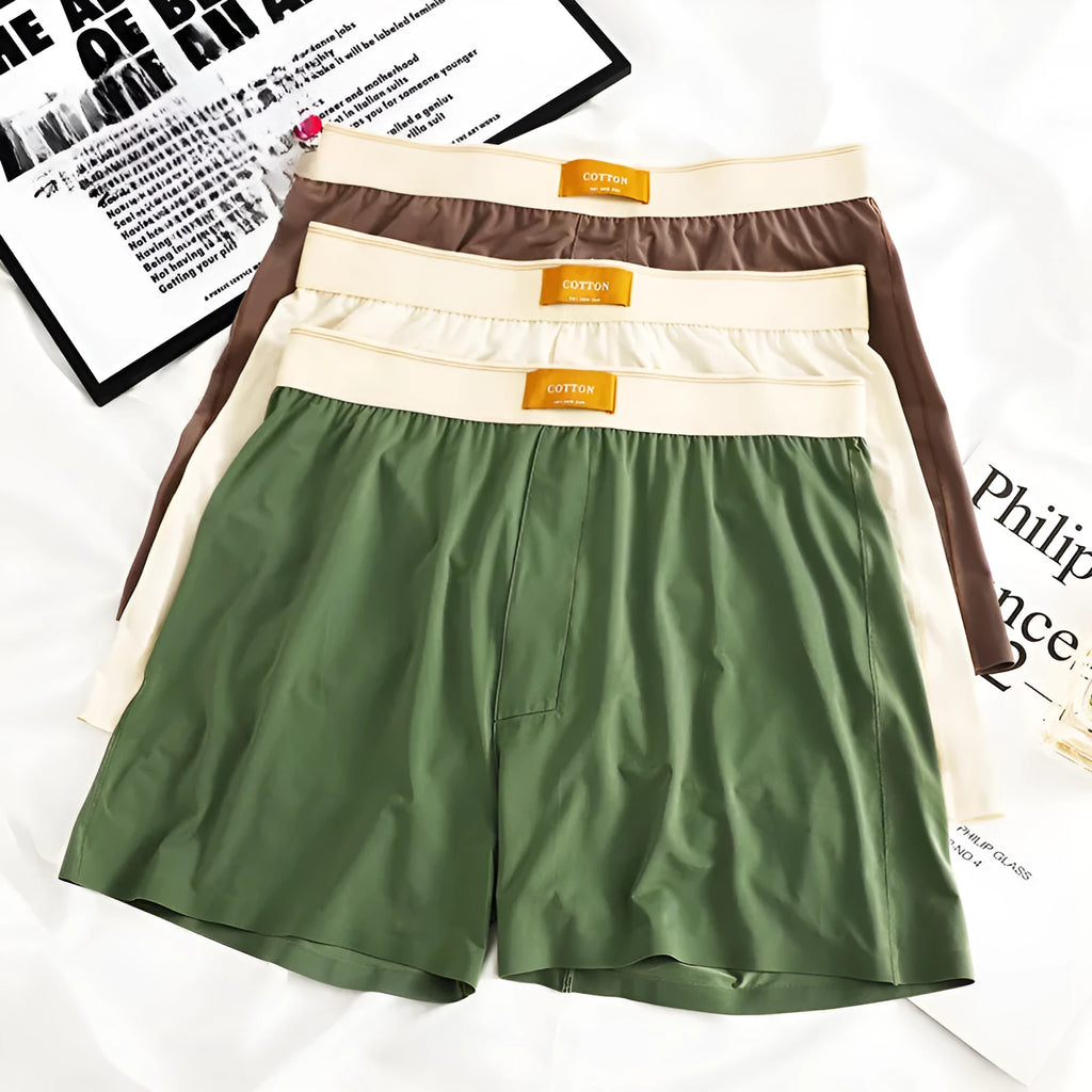 Pack of three men's solid colour loose fit ice silk boxer shorts on a mid waist.