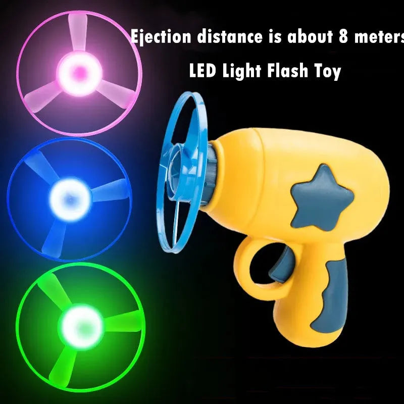 Flying saucer launcher toy with three blue flashing LED discs and target board on blister card