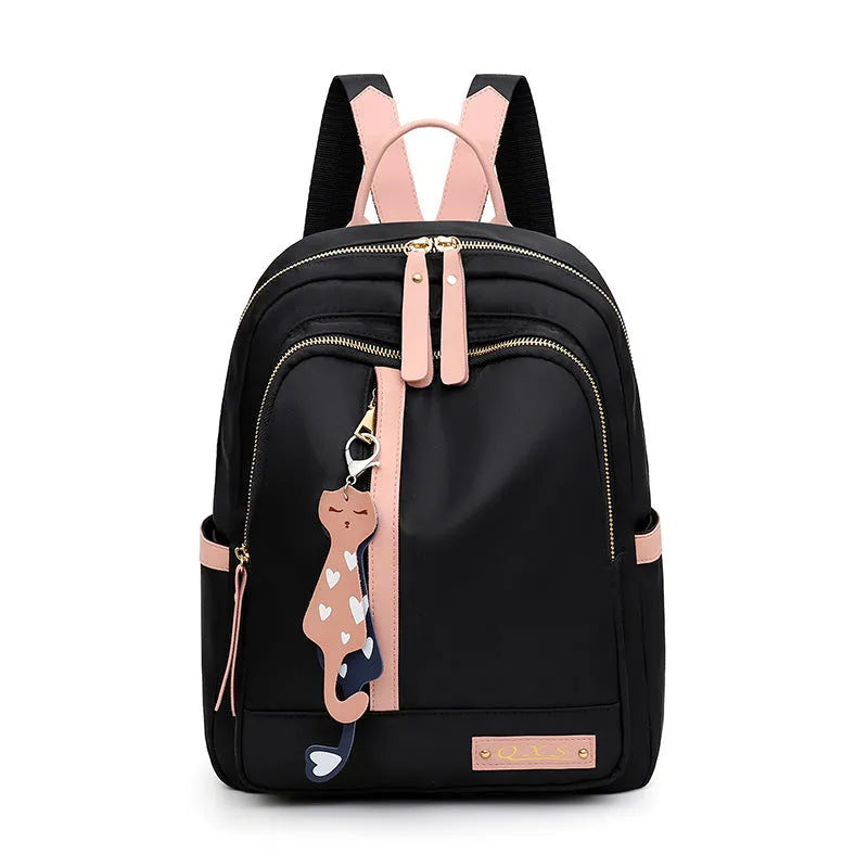 Women's black nylon casual backpack with double shoulder straps, soft handle, and front pocket.