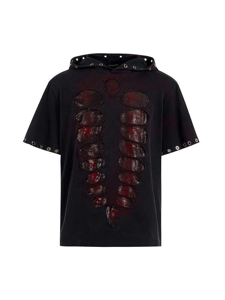 Black loose-fit men's hooded T-shirt covered in reflective sequins, shown in a casual setting.