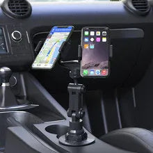 Grey silicone car phone holder Peak-X5 on dashboard with mobile phone inserted