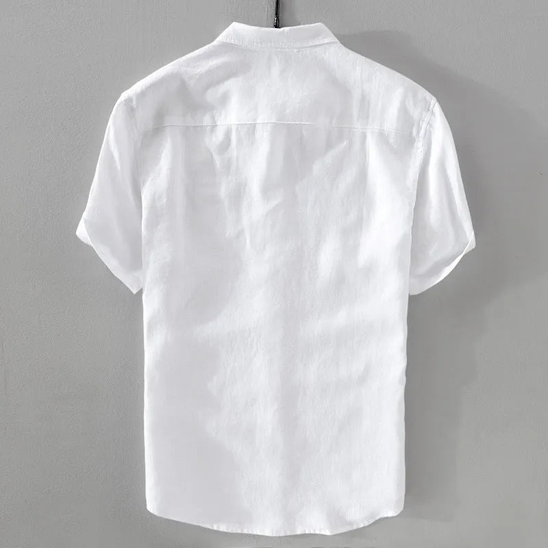 Man wearing a loose-fit short sleeve linen shirt in a light colour, showcasing the casual style.