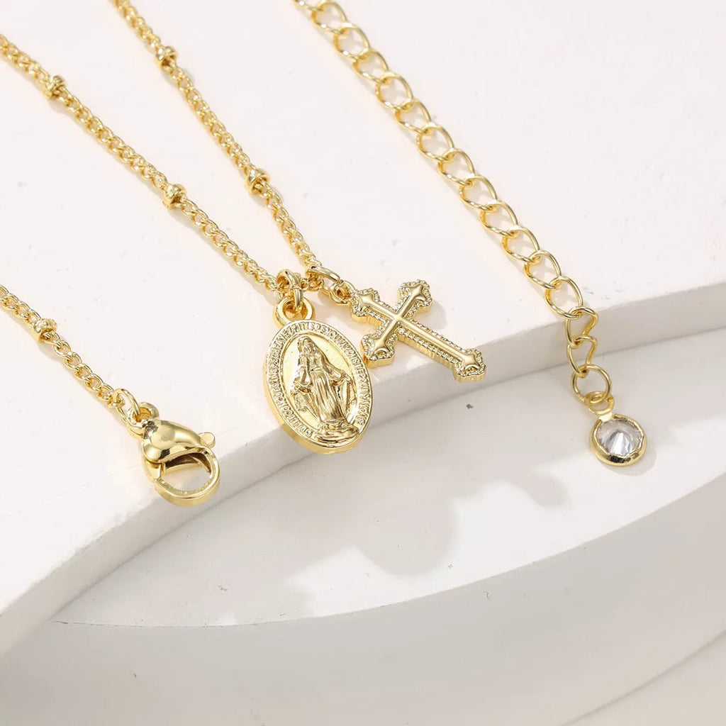 Gold geometric cross Virgin Mary necklace for women on display