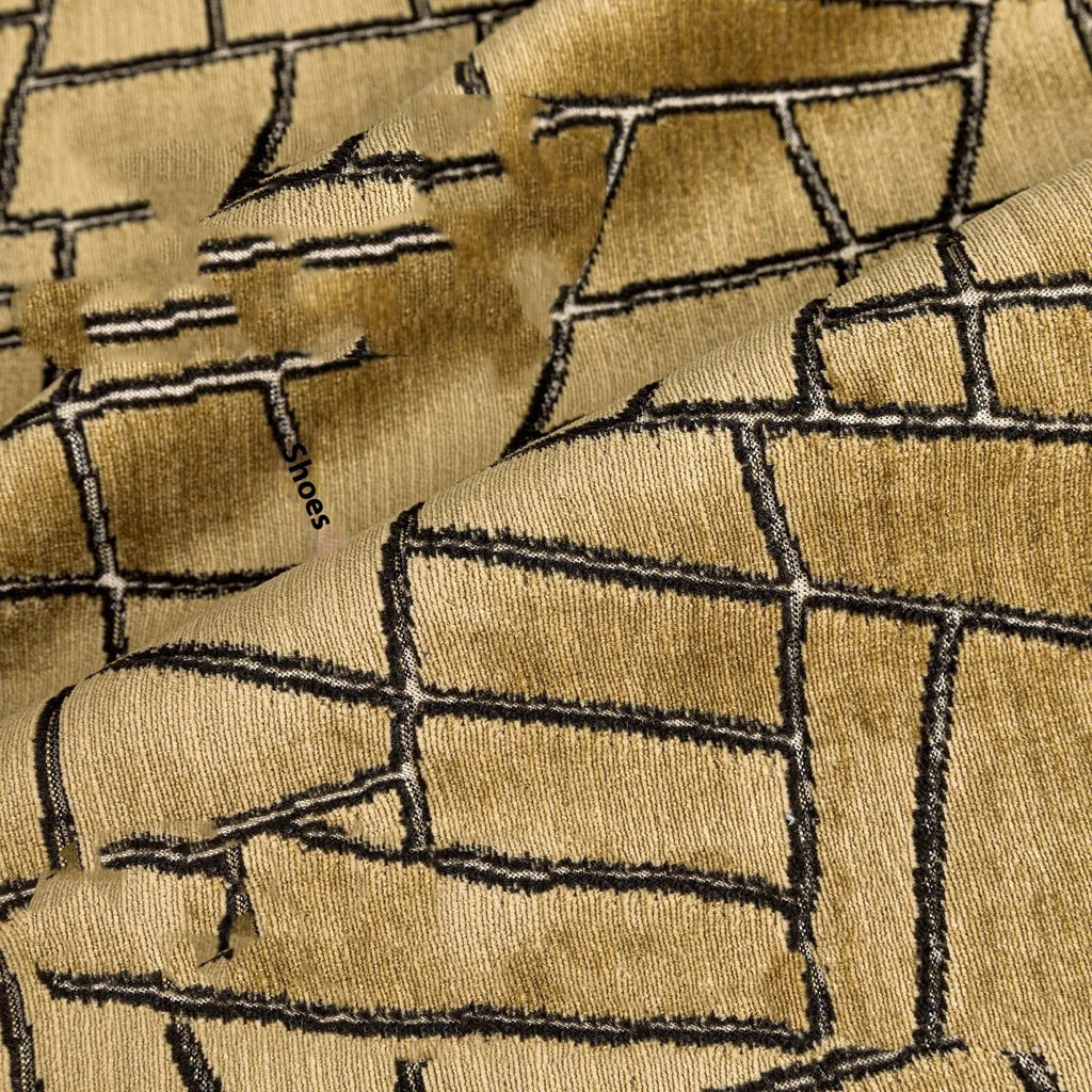 Geometric abstract pattern decorative cushion cover in gold polyester velvet fabric.