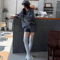 Creamy-white ladies' knitted suit set featuring a geometric cable knit sweater and elastic waist shorts.