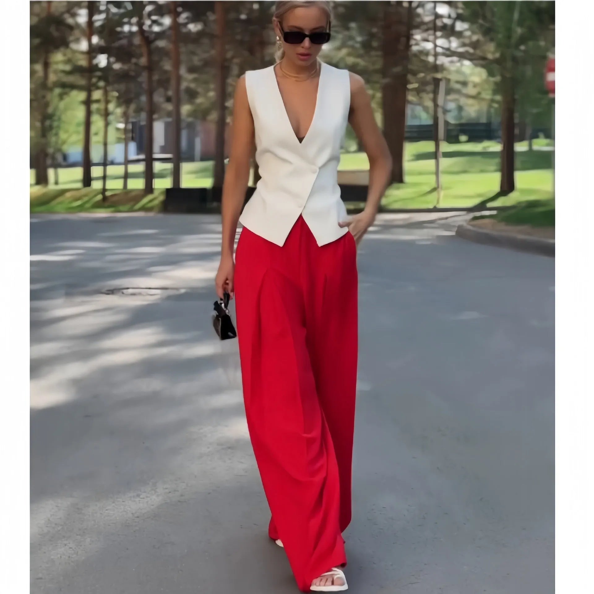 Women's beige deep V-neck sleeveless top and high waist wide leg pants two-piece set on model