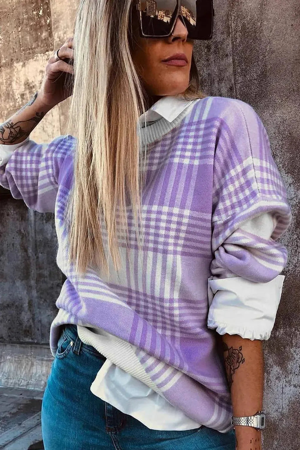 Lilac plaid print loose sweater with ribbed trim and long sleeves on a hanger