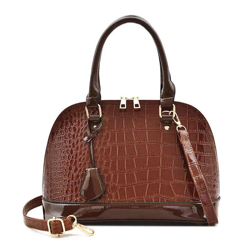 Large shell-shaped shoulder crossbody bag in shiny PU leather with structured silhouette