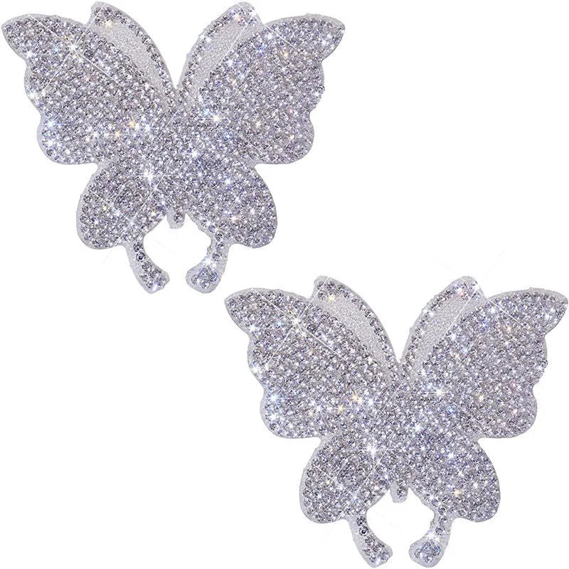 Diamond-encrusted car sticker showing bear paw and butterfly designs on glass with drill stick