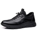 Men's black low heel casual shoes with round toe and square heel on a plain background