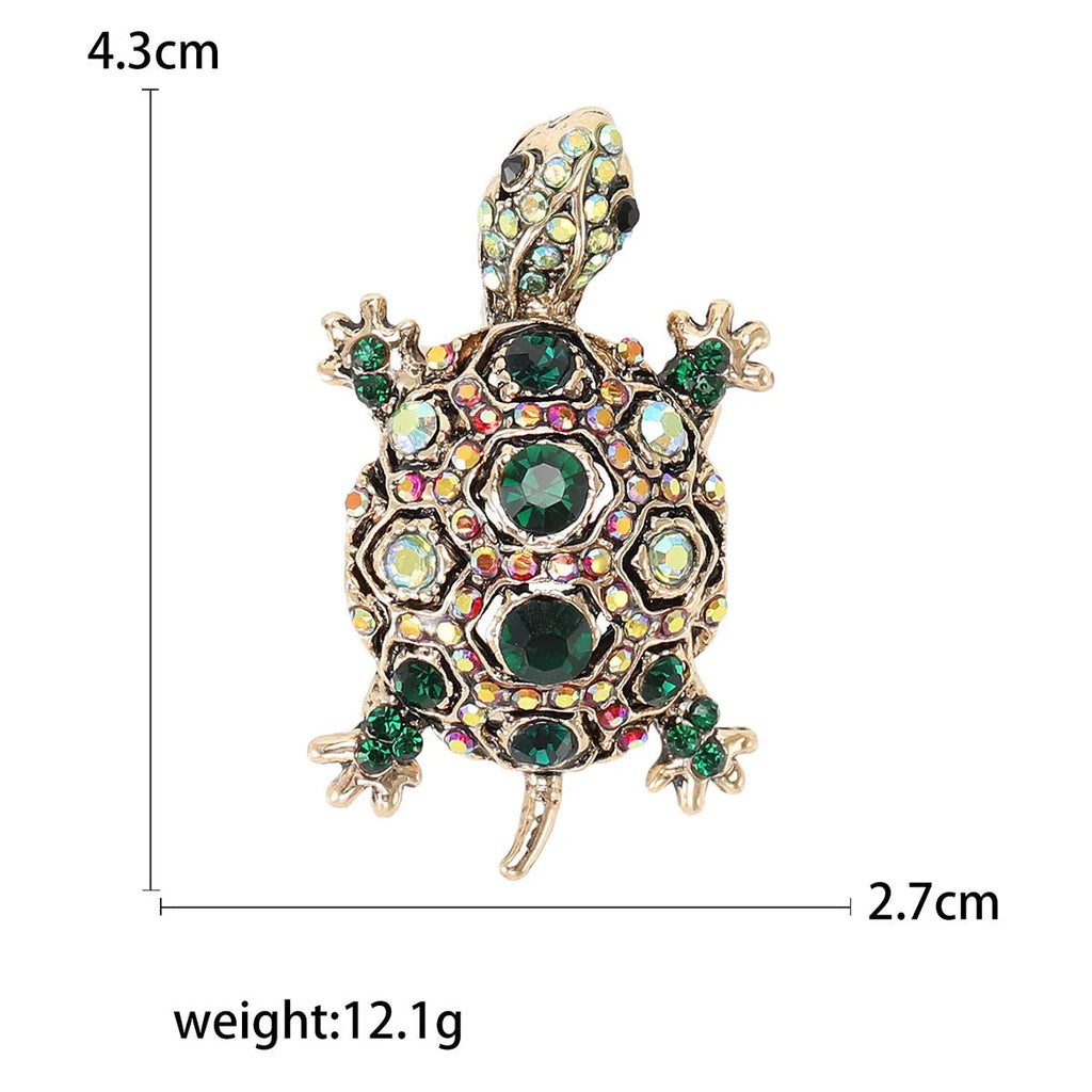 Fashion retro rhinestone turtle brooch in green on a textured surface