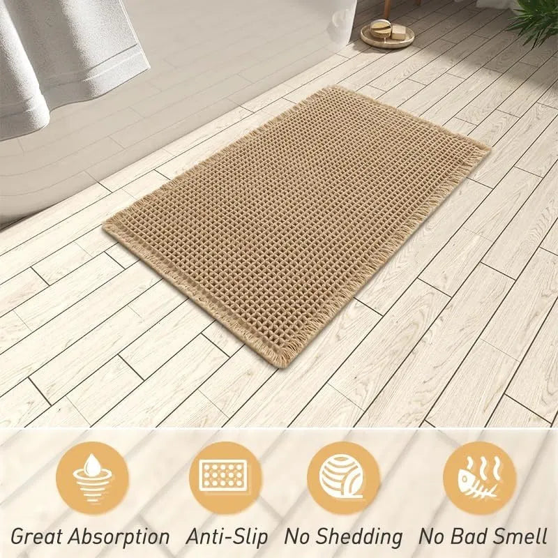 Checkered pattern non-slip polyester bathroom mat in beige colour on tiled floor.