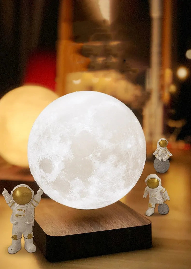 Maglev floating planet night light with three astronaut figures on a desk, showing USB cable and intelligent switch.