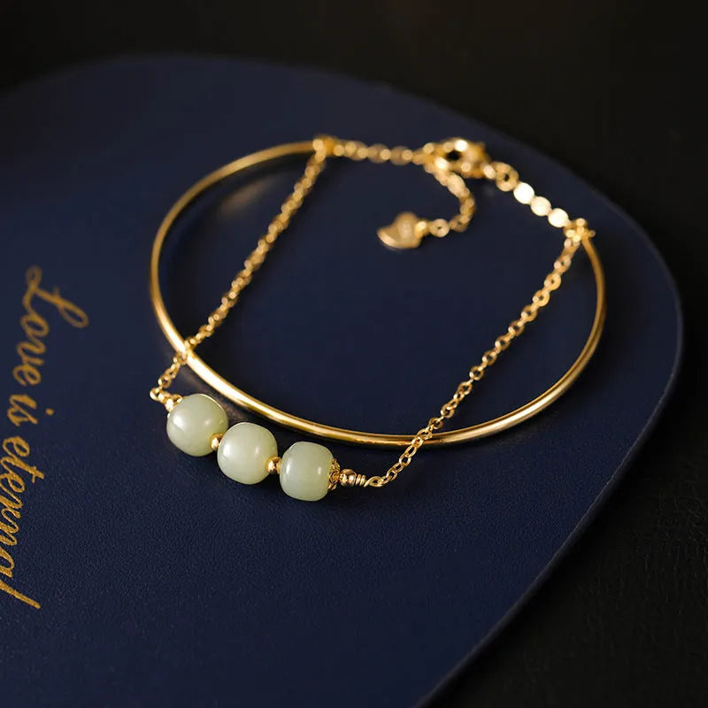 Women's Hetian jade lucky bead bracelet with gold inlay, showing single, double, and three bead version options.