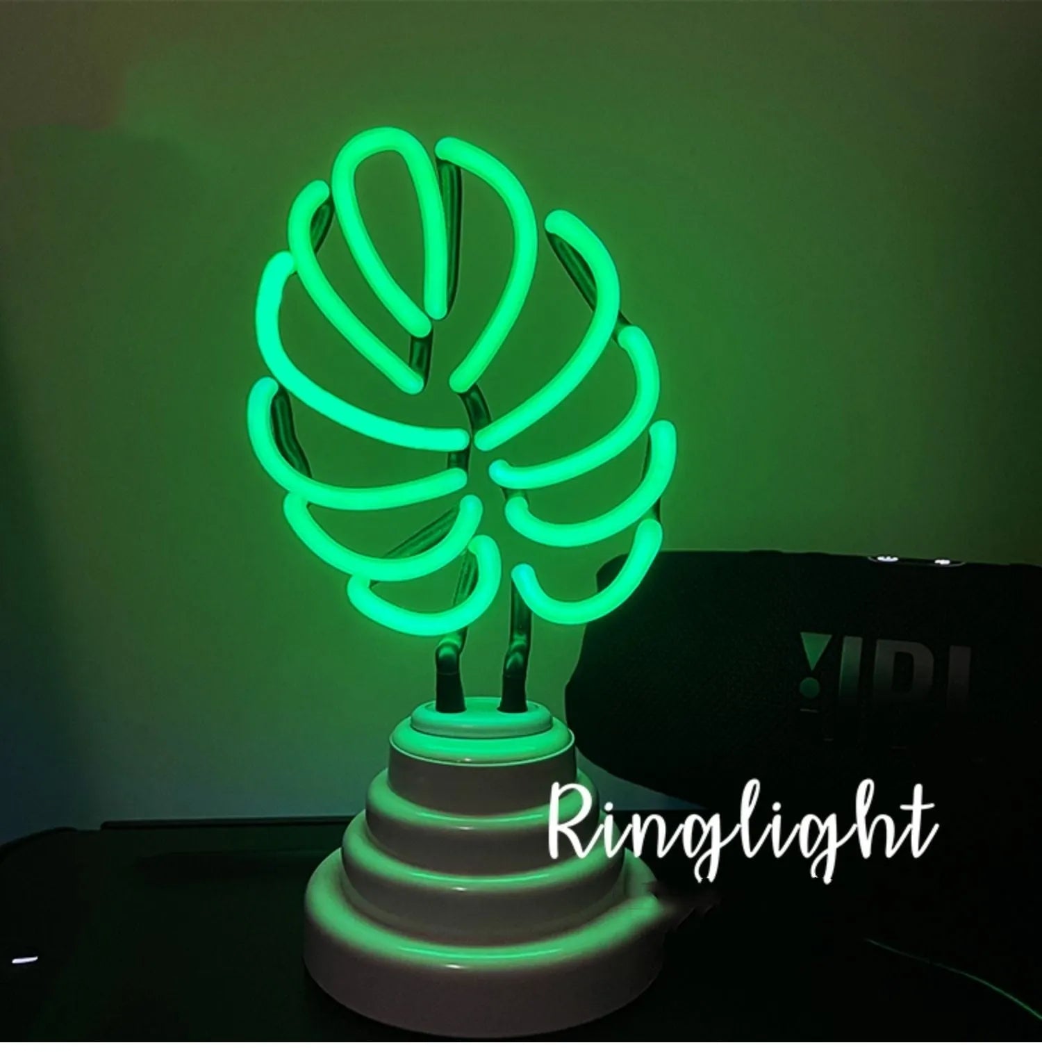 White tube bamboo shape desktop lamp emitting green light, with USB cable.