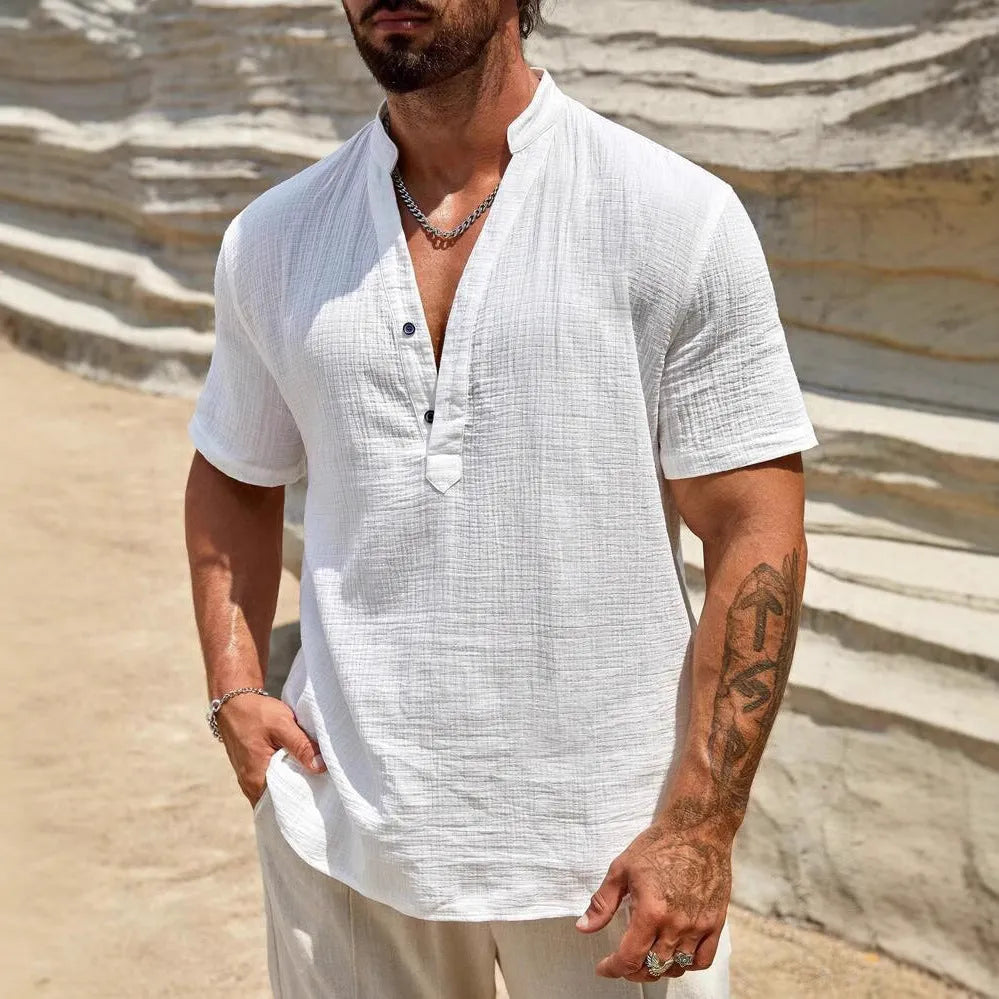 Men's solid colour stand collar short-sleeved shirt in a light blue shade, showing the slit detail and casual fit.