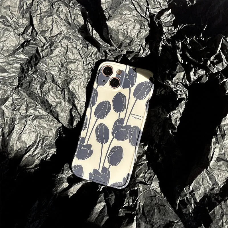 Black silicone iPhone case with a white tulip floral graphic on the back