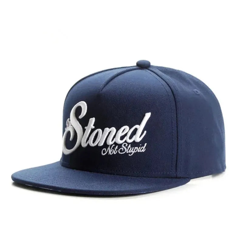 Navy blue cotton baseball cap with machine-embroidered English letters on front, dome crown, adjustable back strap