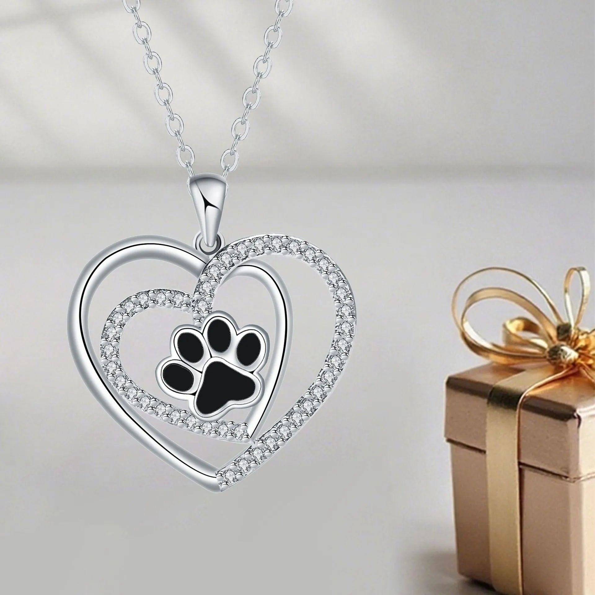 Women's silver-tone necklace with dog paw footprint pendant on cross chain