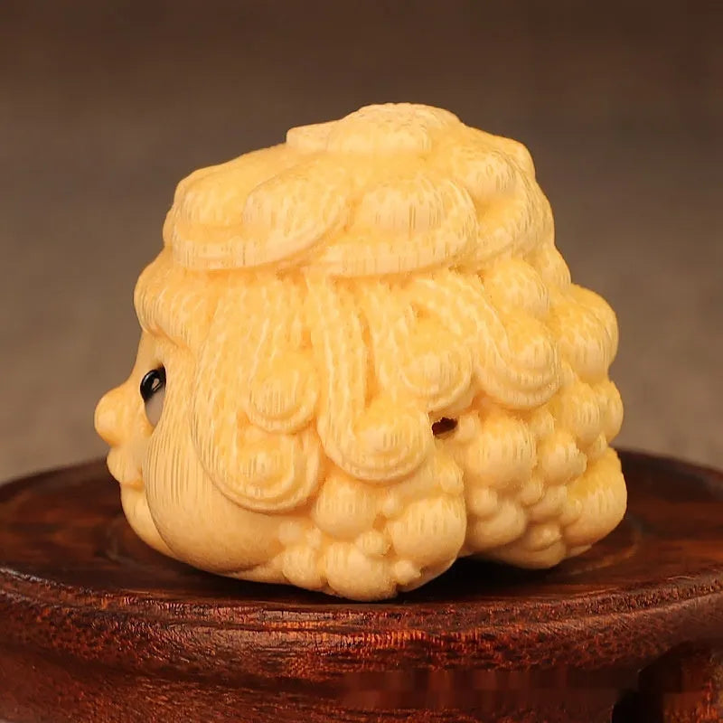 Solid bamboo carving of a cute Golden Toad Princess ornament on a white background.
