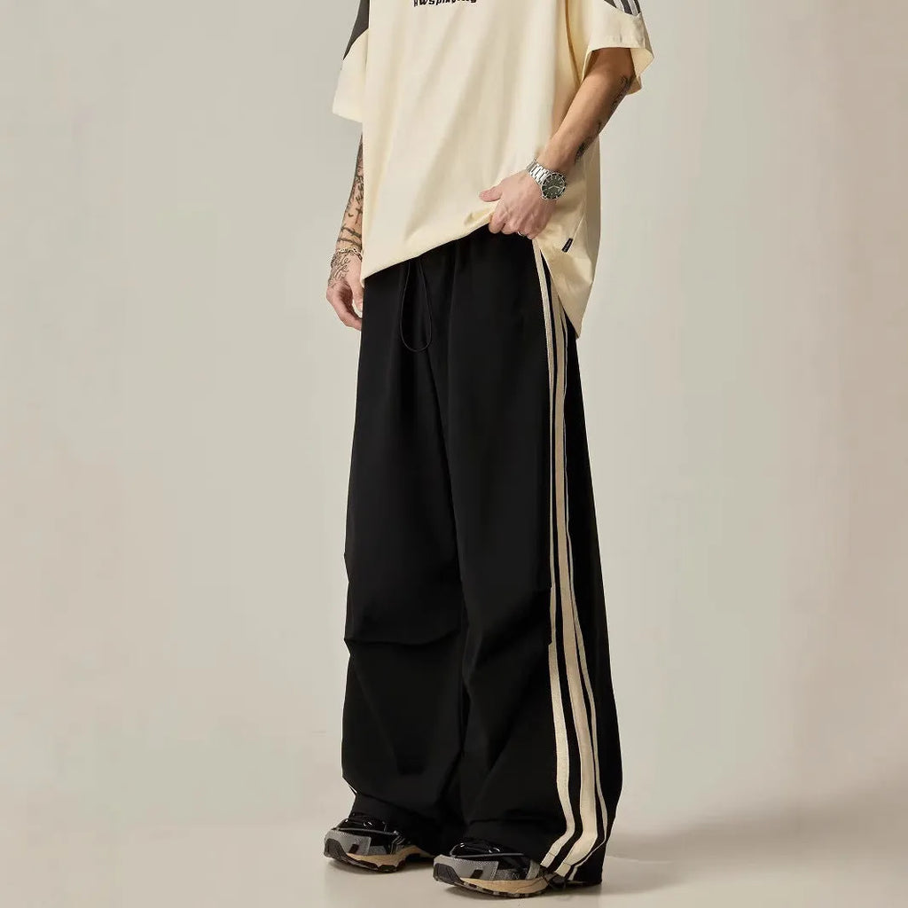 Black men's wide-leg climbing pants with a high waist and long straight-leg design on a neutral background.