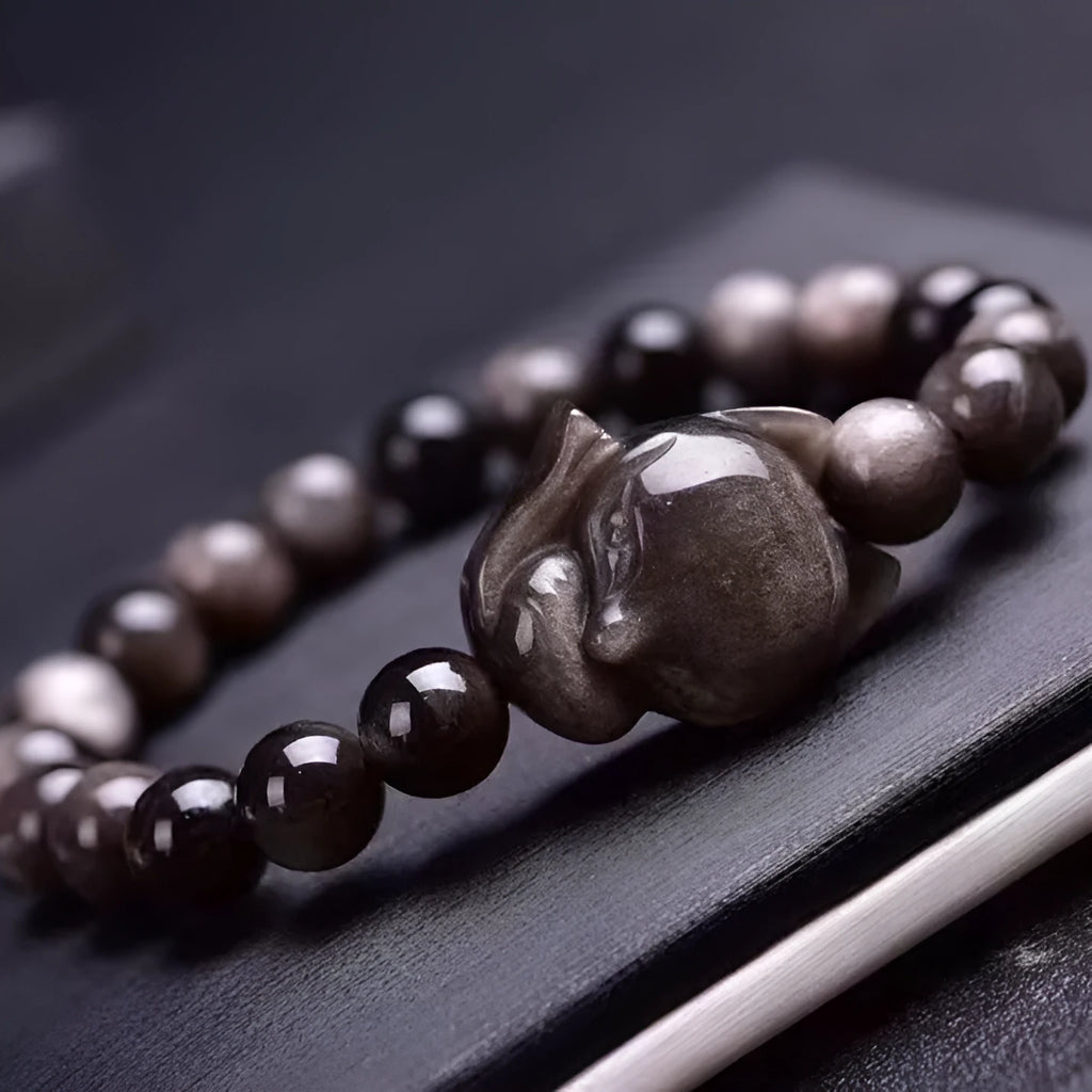 Obsidian bracelet with fox ring charm on 8mm polished black stone beads showing adjustable sliding knot closure