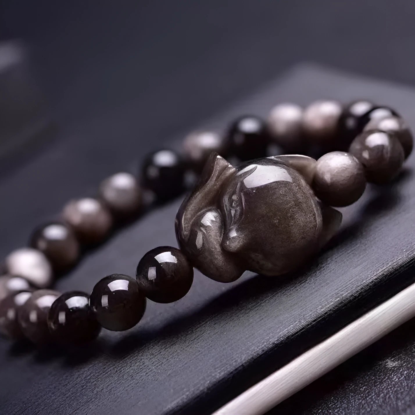 Obsidian bracelet with fox ring charm on 8mm polished black stone beads showing adjustable sliding knot closure