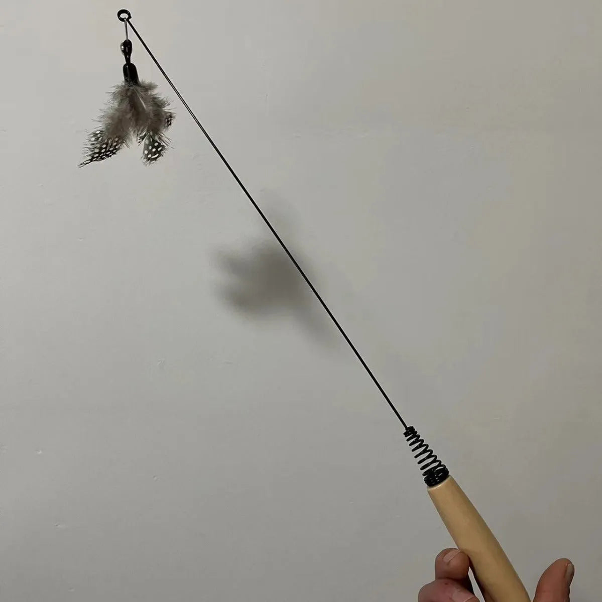 Cat teasing stick with wooden handle, spring, feather head and bell, available in multiple colours