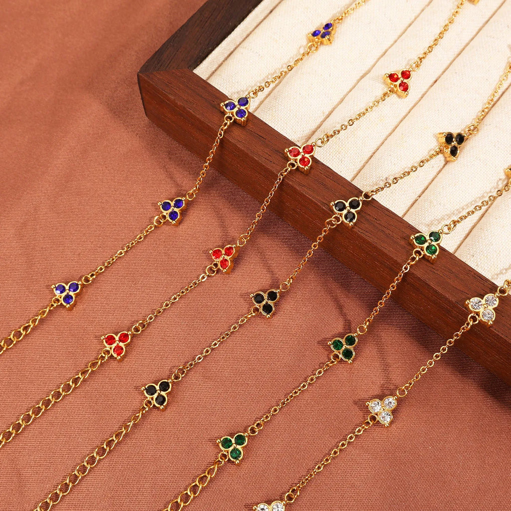 Women's stainless steel bracelet with three triangular diamond charms in geometric design with coloured stones