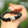 Close-up of a women's bracelet with large 10mm black agate beads on a shiny silver alloy chain in a Chinese style.