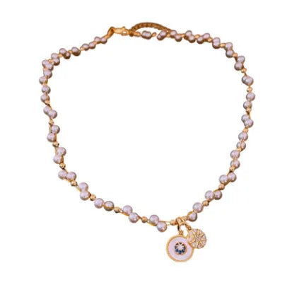 Gold electroplated round pendant necklace with zircon pearl on an adjustable clavicle chain.
