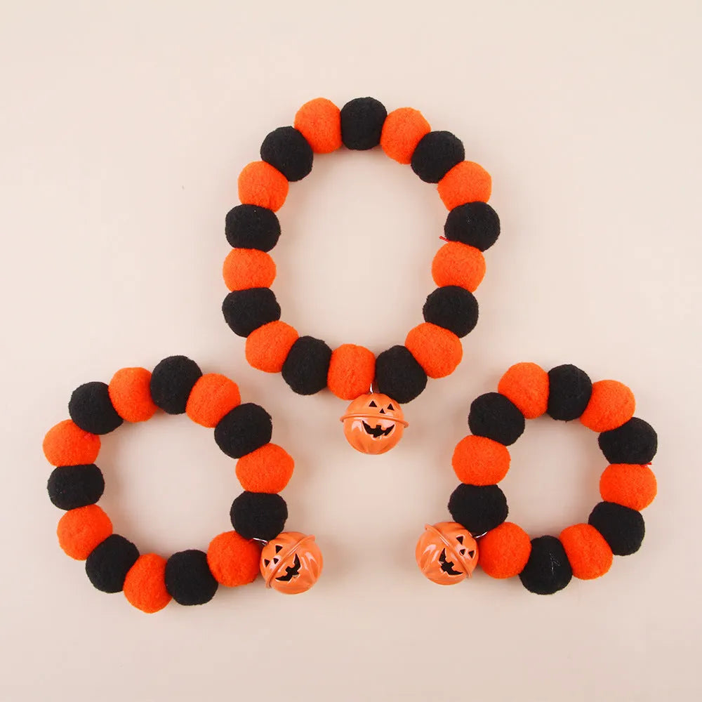 Orange pumpkin Halloween cat collar with green stem on an adjustable strap for pets.
