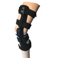 Black anterior cruciate ligament knee brace with visible metal side stays and hinges on a leg.