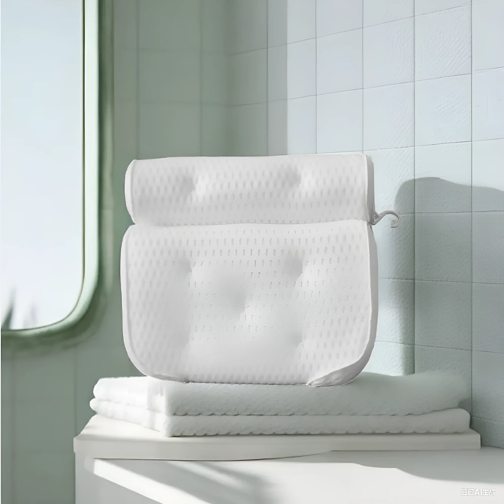 White bathtub pillow with mesh fabric and suction cups on a bathtub edge.