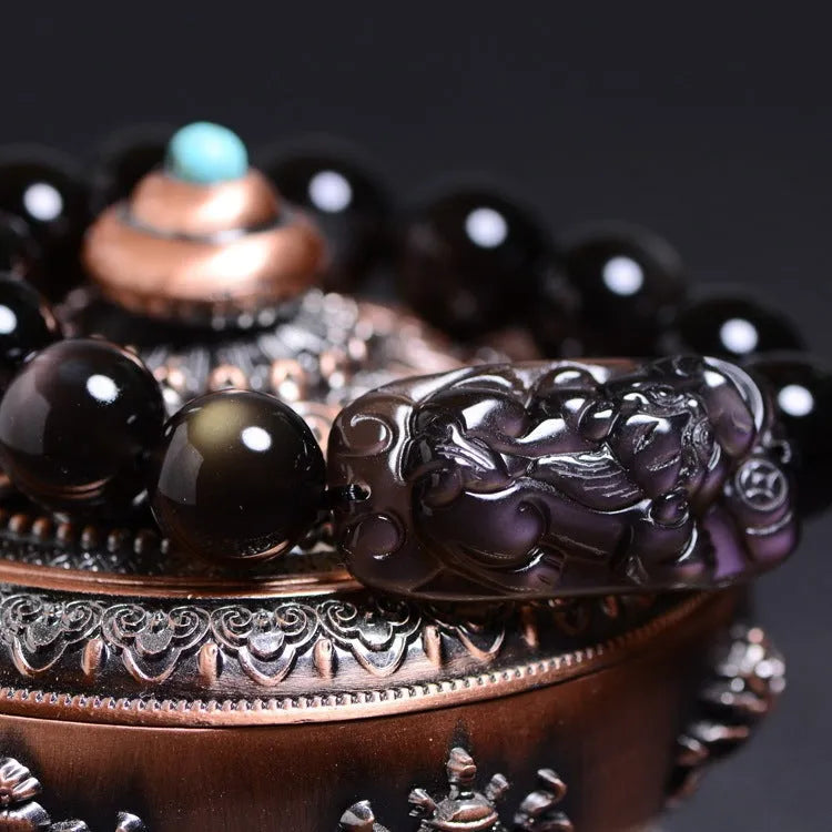 Genuine crystal icy obsidian Pi Xiu bracelet in geometric ethnic style on a neutral background.