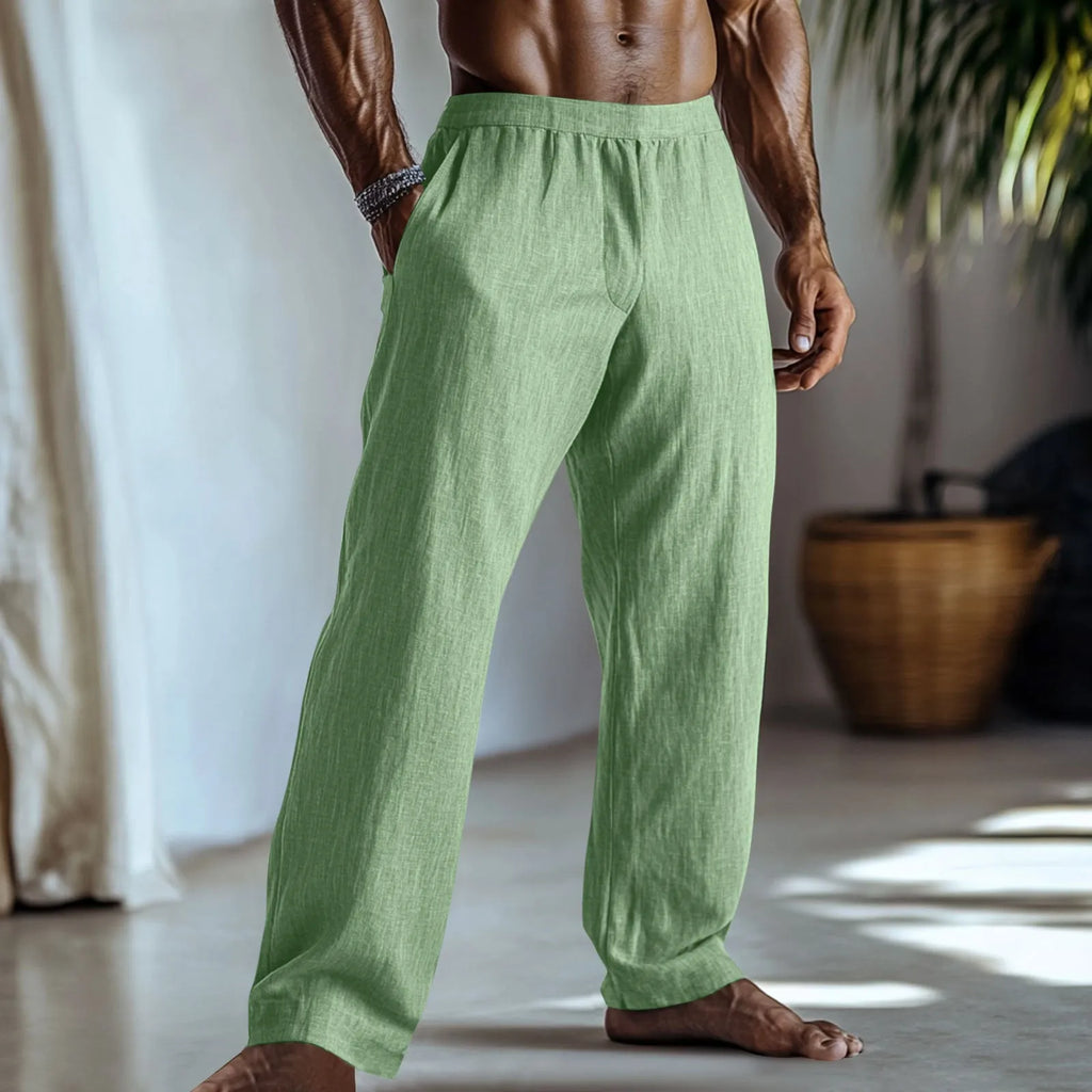 Straight-leg cotton linen trousers in light green colour with visible pockets and British style design.
