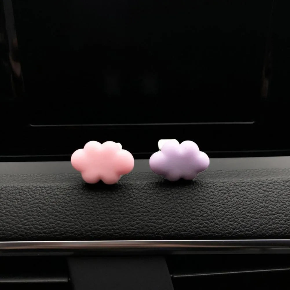 Resin cartoon car fragrance clip in one of six colours attached to vehicle air vent