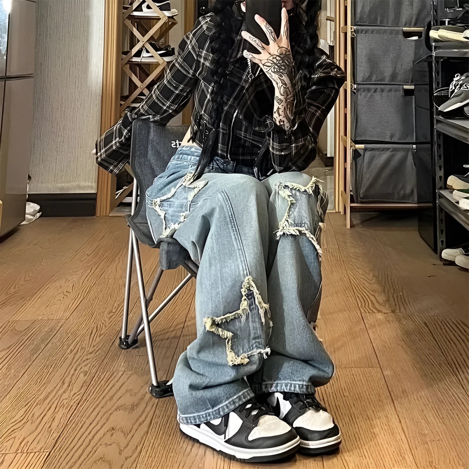 Blue high-waisted wide-leg women's denim trousers on a hanger.