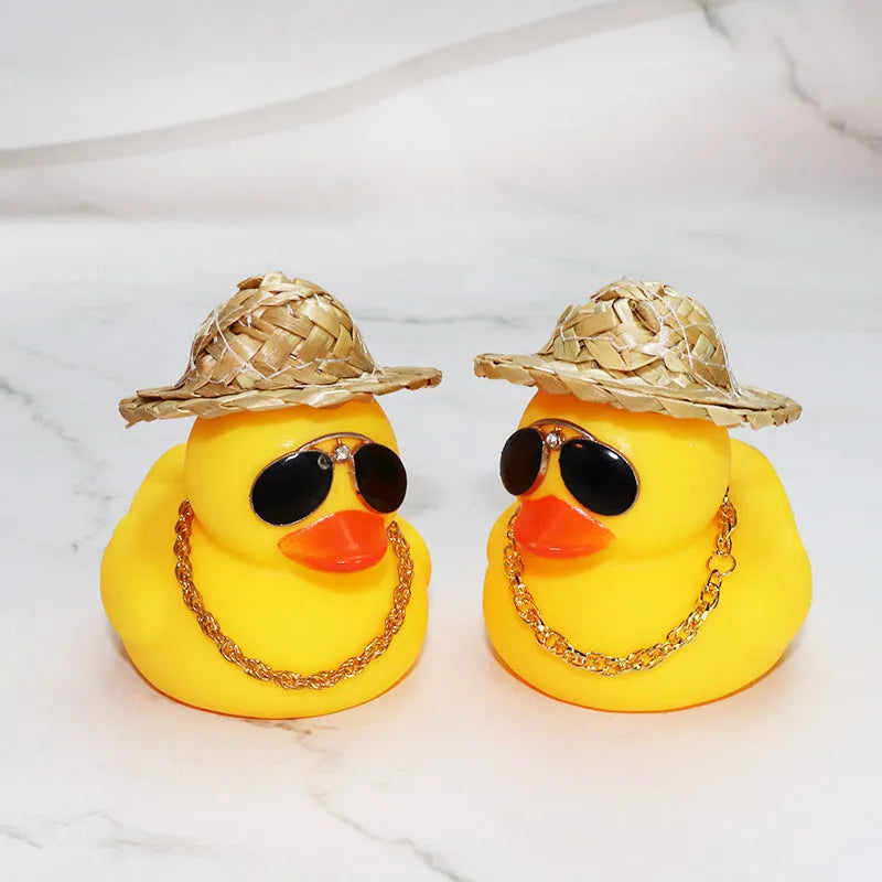 Yellow cartoon duck wearing a straw hat car dashboard ornament with adhesive and sunglasses accessory.