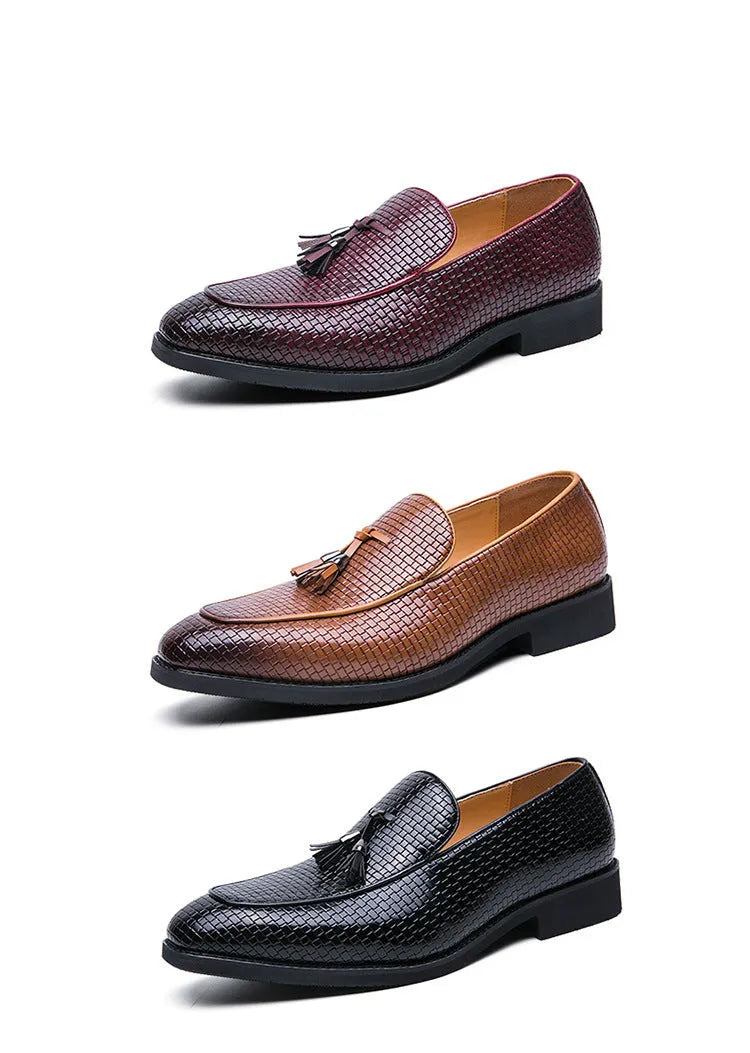Men's black pointed toe slip-on shoes with a decorative tassel on the front.