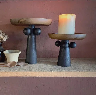 Nordic style wooden tray with four raised legs holding candles and aromatherapy bottles