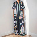 Black women's casual set with cartoon print, featuring a cardigan and trousers