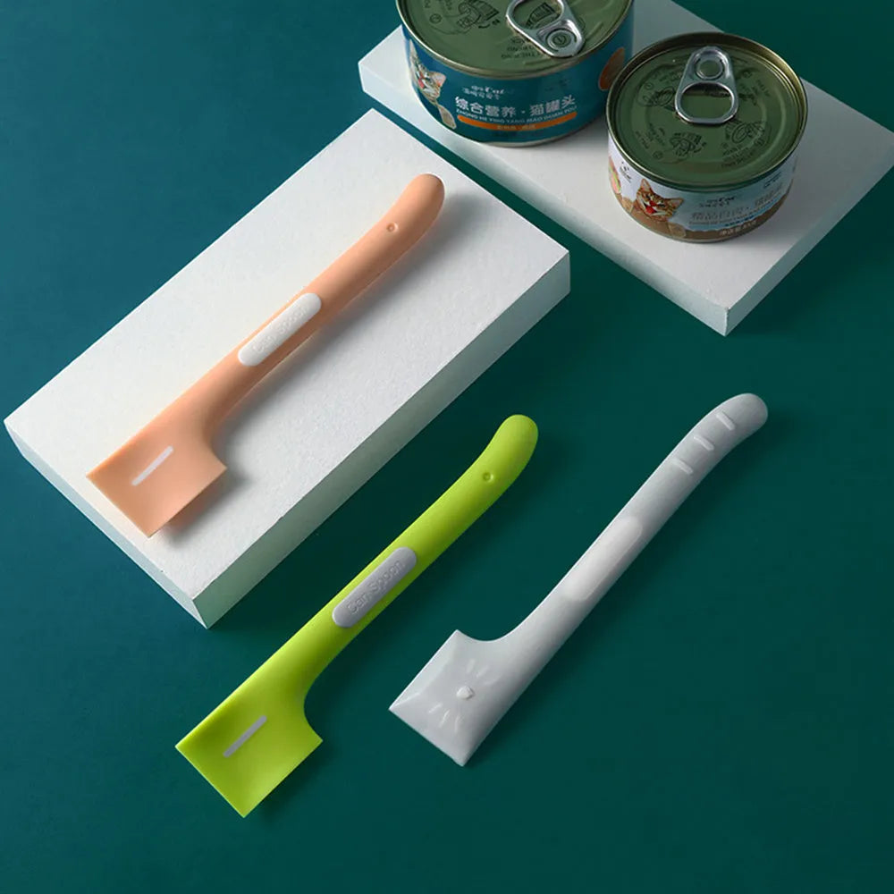 Green long-handled TPR spoon for scooping pet canned food on a white background